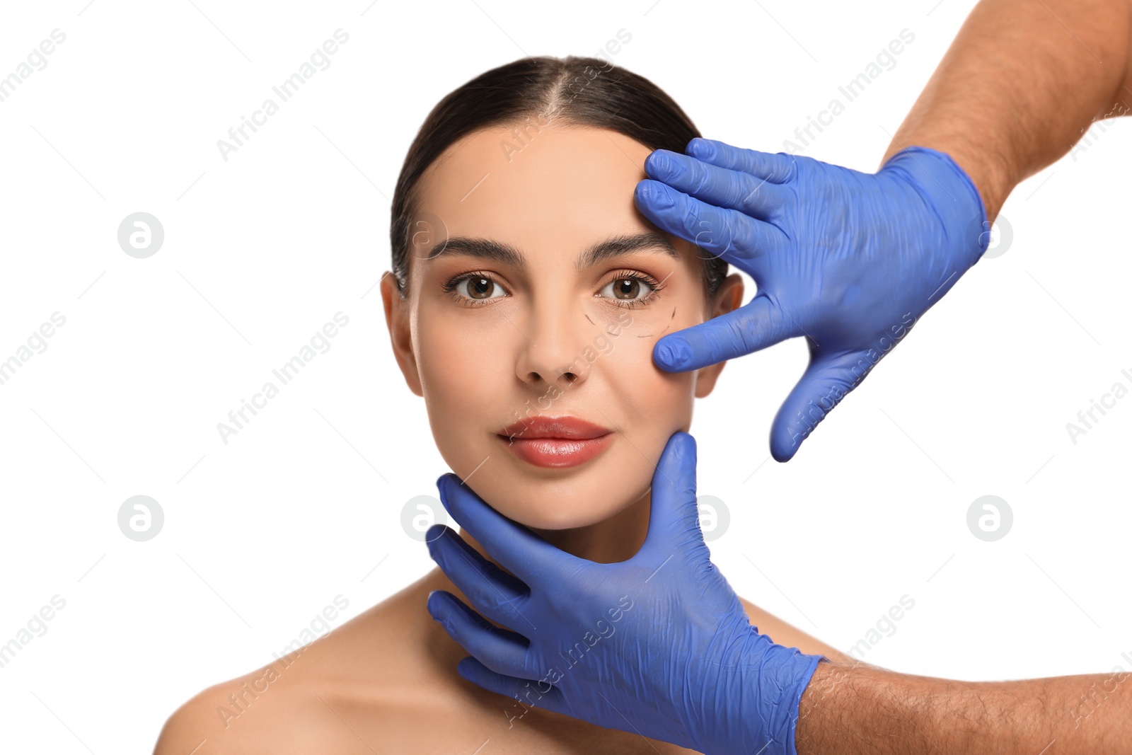 Photo of Doctor checking patient's face before cosmetic surgery operation on white background