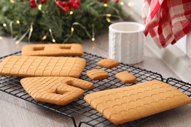 Photo of Parts of gingerbread house on wooden table, closeup