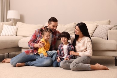 Photo of Happy family spending time together in living room