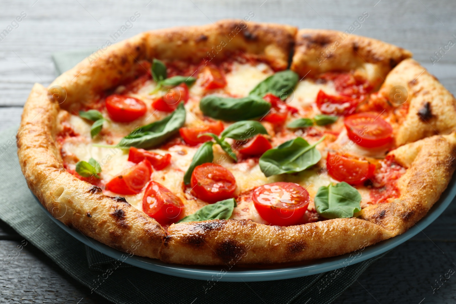 Photo of Delicious Margherita pizza on gray table, closeup