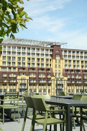 Photo of Observation area cafe. Tables and chairs on terrace against beautiful cityscape