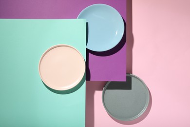Photo of Abstract composition made of plates on color background, flat lay