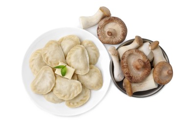 Photo of Delicious dumplings (varenyky) with mushrooms and butter isolated on white, top view