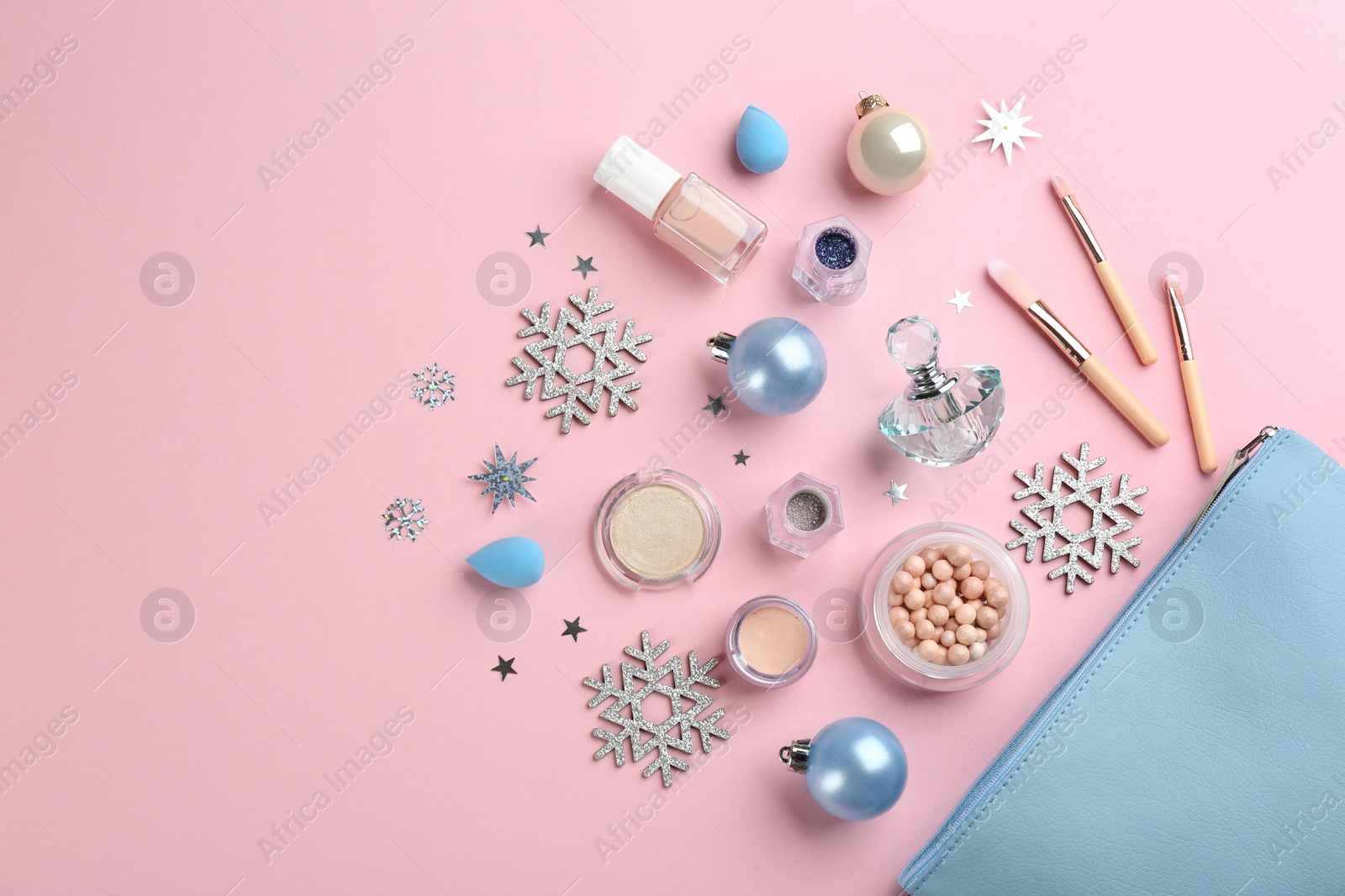 Photo of Flat lay composition with decorative cosmetic products on pink background. Winter care