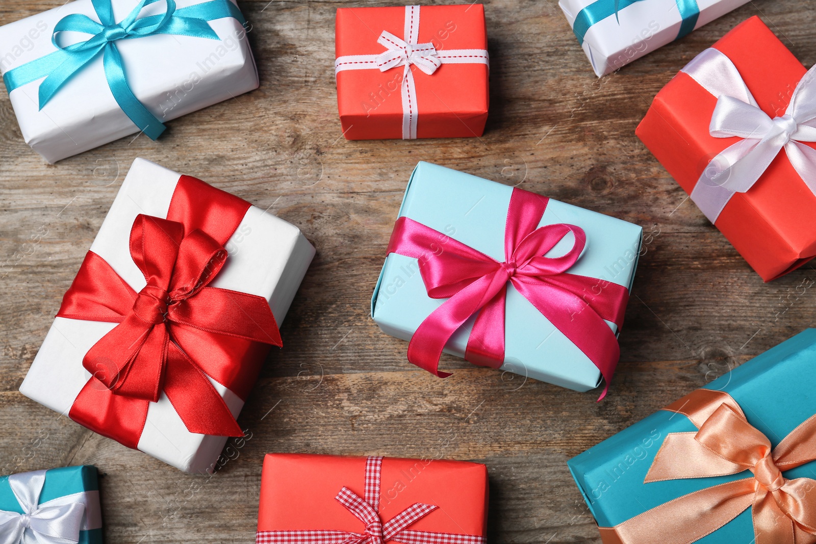 Photo of Flat lay composition with beautiful gift boxes on wooden background