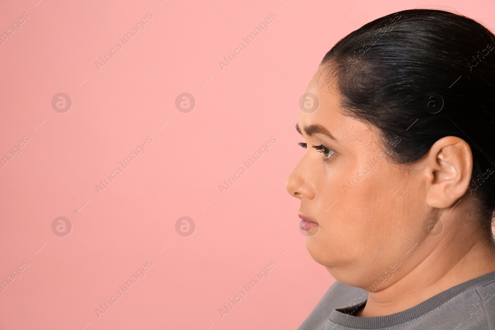 Photo of Woman with double chin on pink background. Space for text