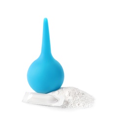 Photo of Light blue enema, soda powder and suppository on white background