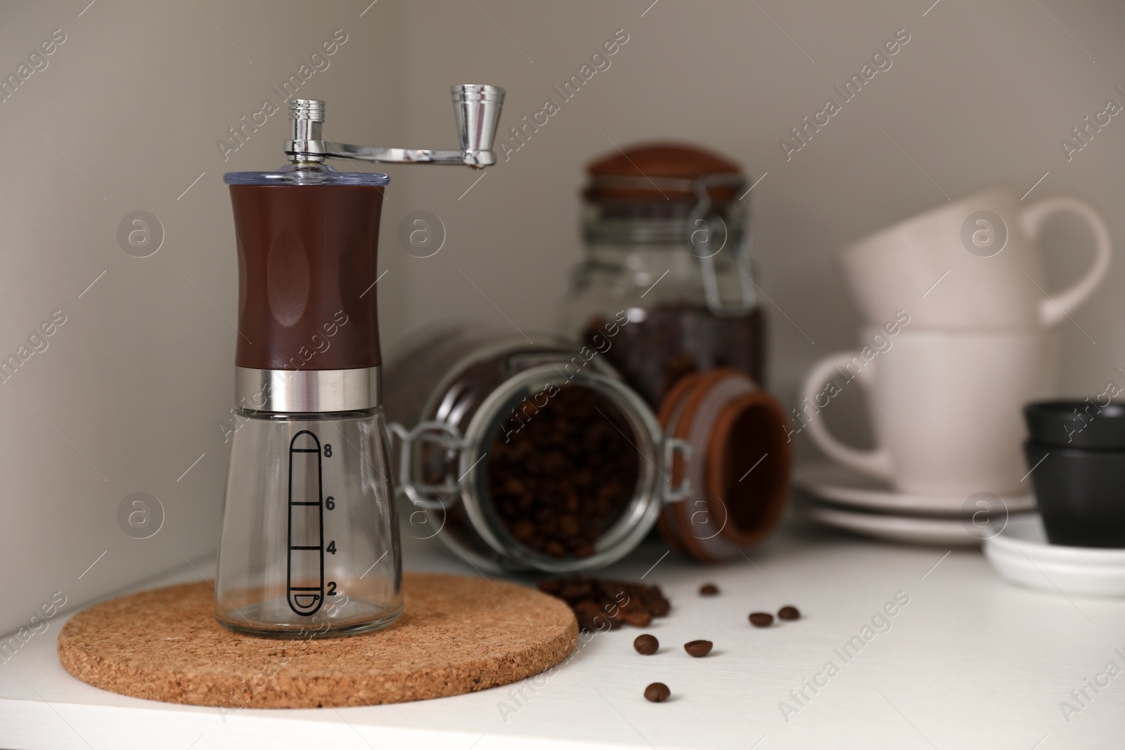 Photo of Manual coffee grinder on shelf in kitchen