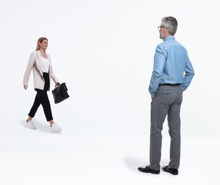 Image of Small woman walking towards to giant man on white background