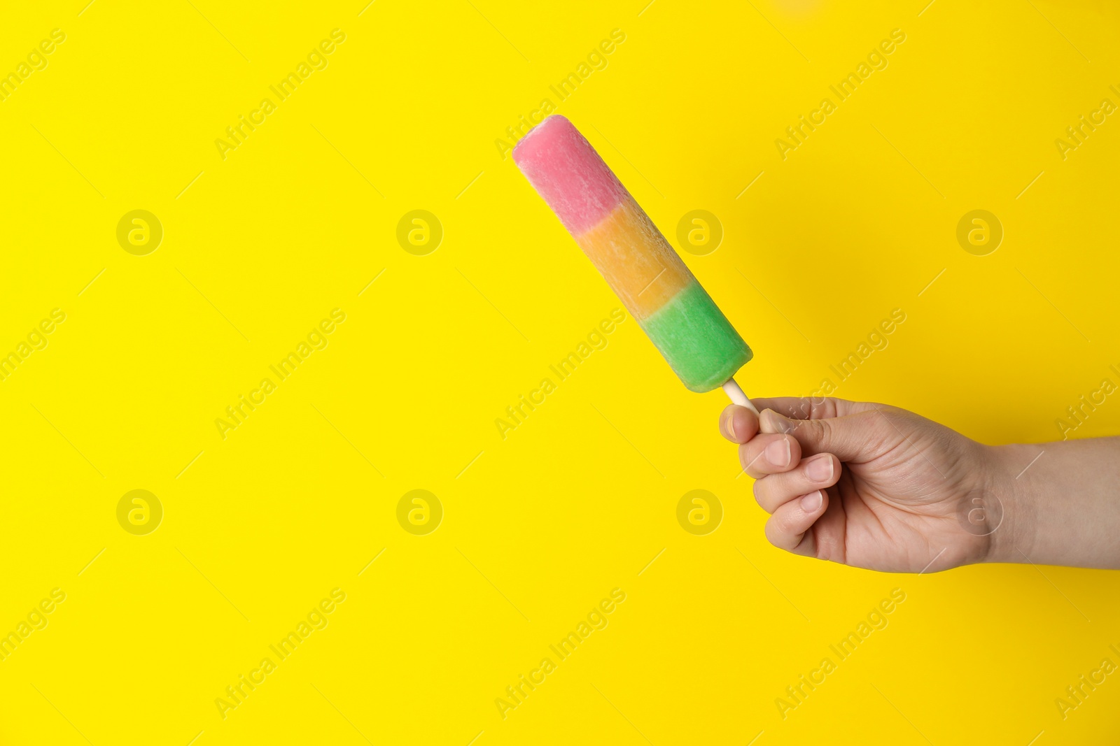 Photo of Woman holding delicious ice cream against color background, space for text