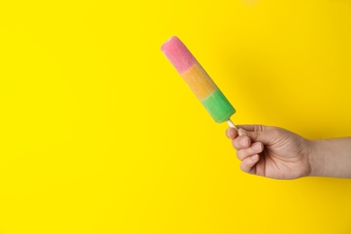 Photo of Woman holding delicious ice cream against color background, space for text