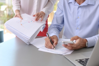 Tax accountants working with documents at table