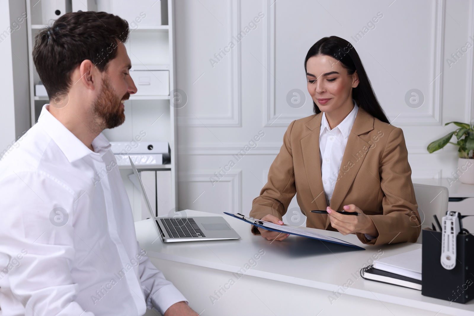 Photo of Human resources manager reading applicant's resume in office