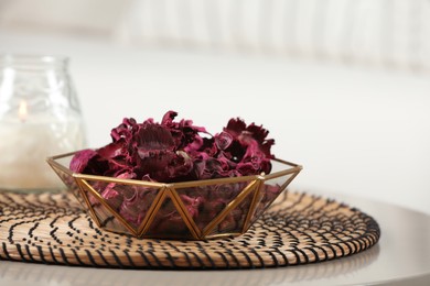 Photo of Aromatic potpourri of dried flowers in bowl on white table indoors