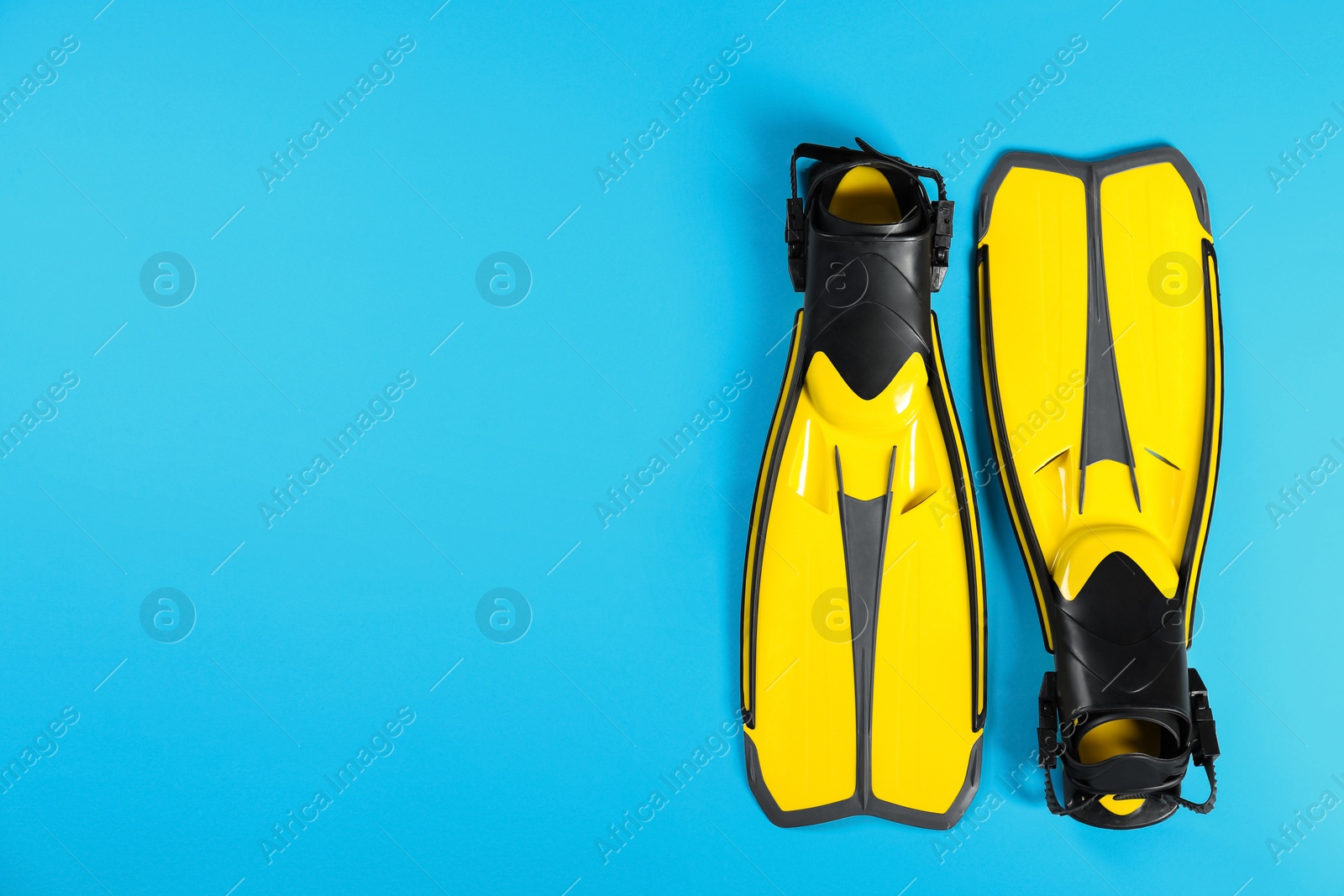 Photo of Swimming flippers on color background, top view. Space for text