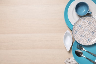 Flat lay composition with beautiful dishware on wooden table. Space for text