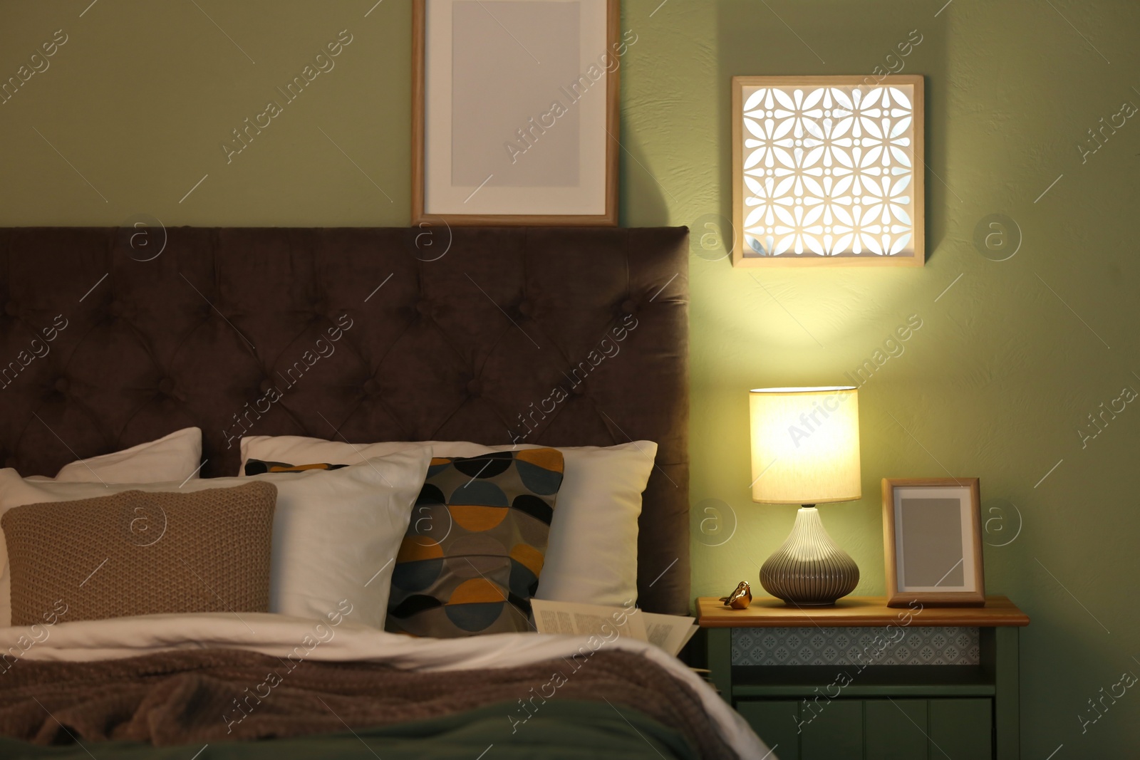 Photo of Modern room interior with comfortable bed and stylish lamp