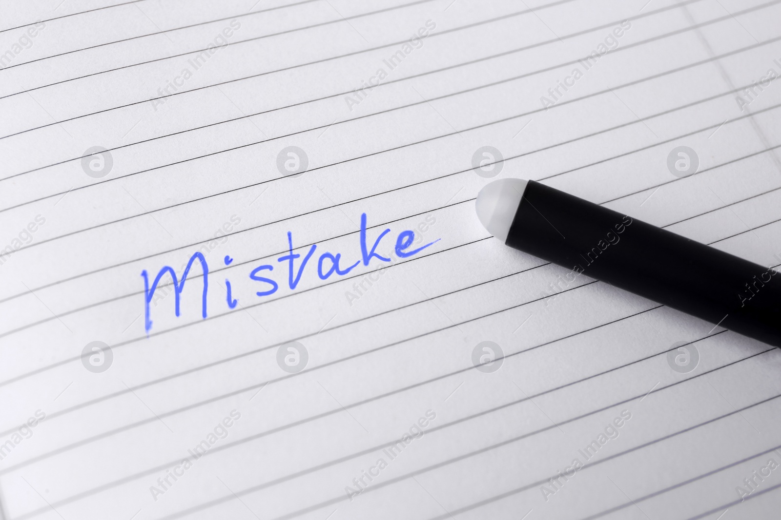 Photo of Word Mistake written with erasable pen on lined sheet of paper, closeup