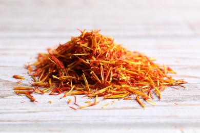 Aromatic saffron on wooden table, closeup view