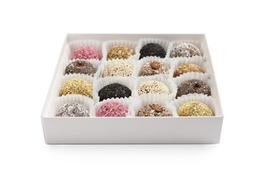 Photo of Different delicious vegan candy balls in box on white background
