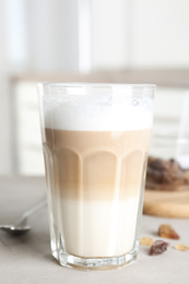 Delicious latte macchiato in glass on grey table indoors