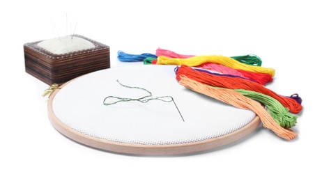 Photo of Colorful threads and different embroidery accessories on white background