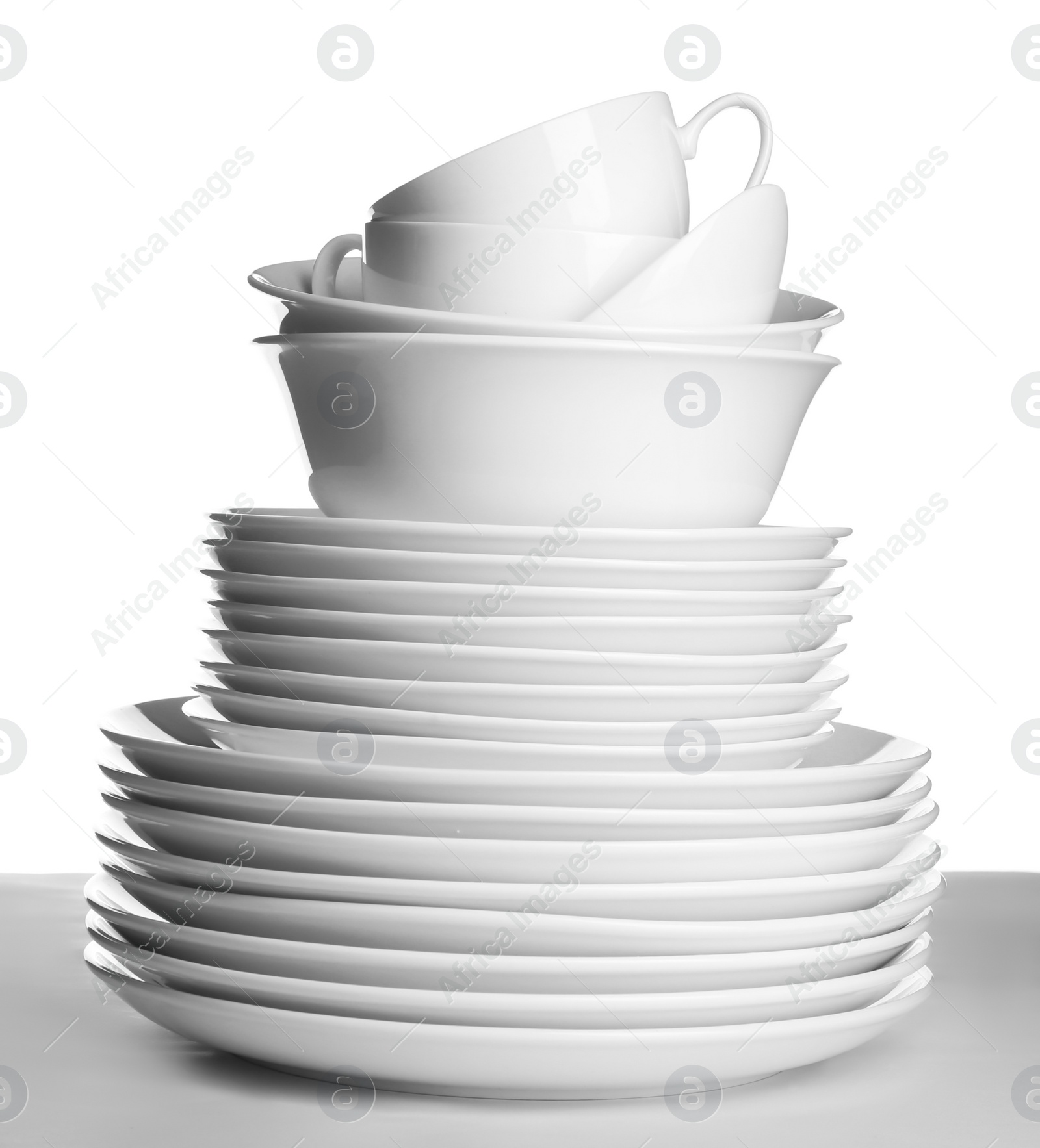 Photo of Stack of ceramic tableware on white background