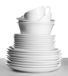 Photo of Stack of ceramic tableware on white background