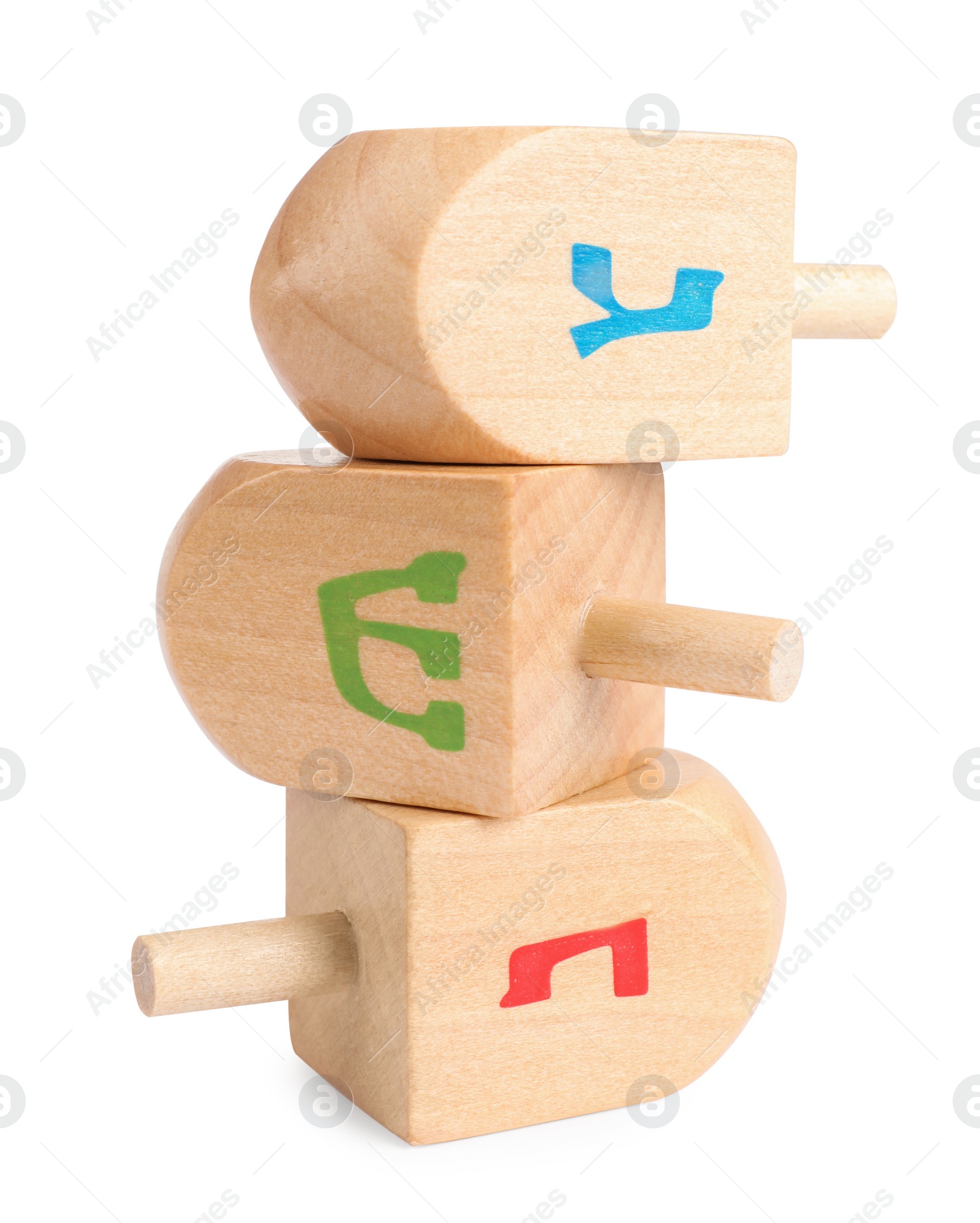 Photo of Hanukkah celebration. Wooden dreidels with jewish letters isolated on white