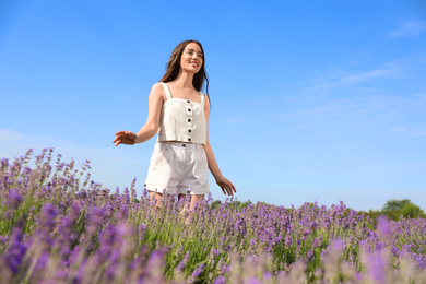 Young woman in lavender field on summer day