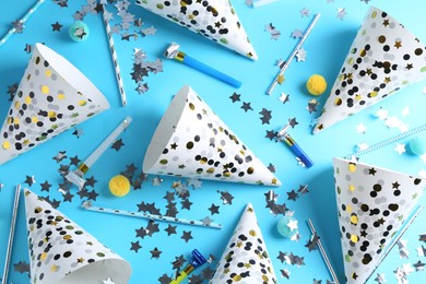 Photo of Flat lay composition with party hats on light blue background