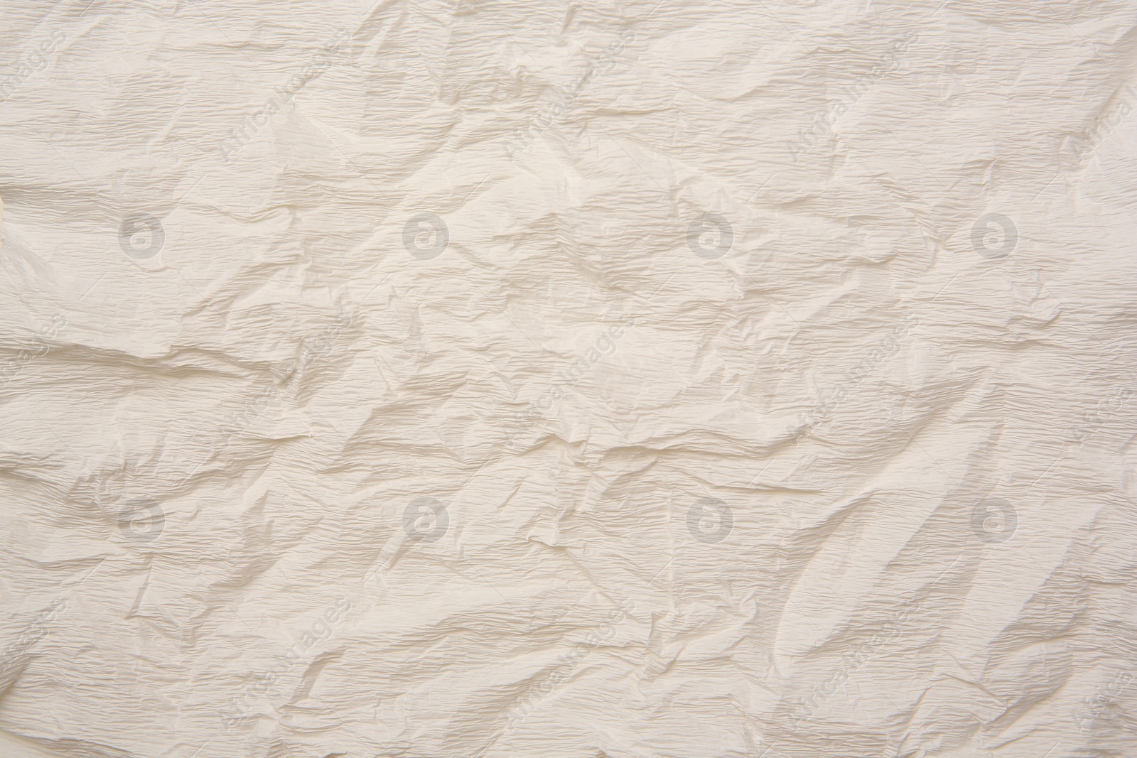 Photo of Texture of crumpled beige paper as background, closeup view