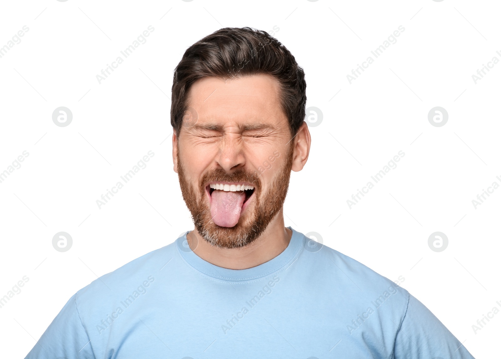 Photo of Man showing his tongue on white background