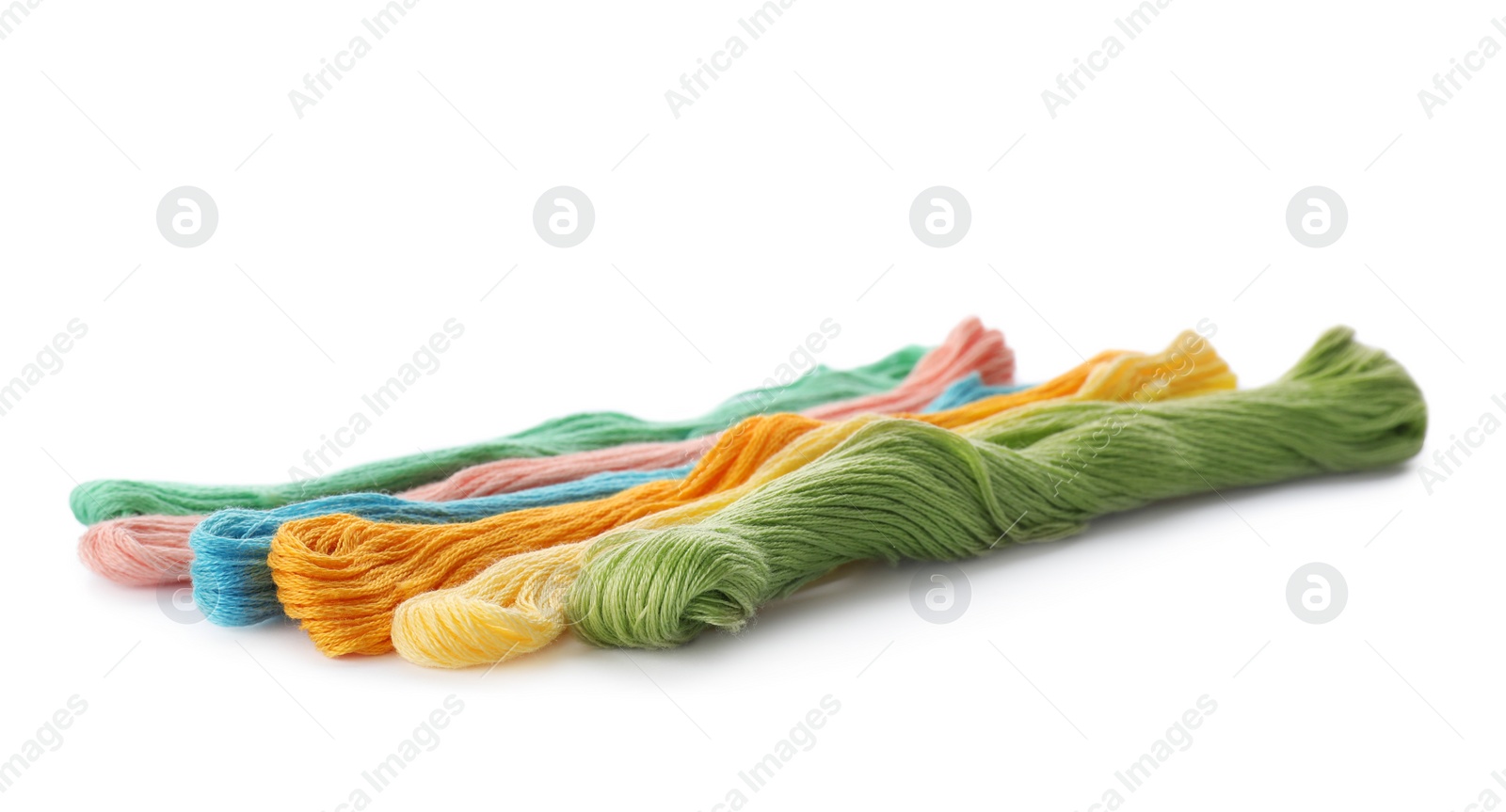 Photo of Color sewing threads on white background