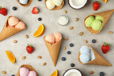 Flat lay composition with delicious ice creams in waffle cones on table