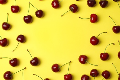 Photo of Flat lay composition with sweet cherries on yellow background. Space for text