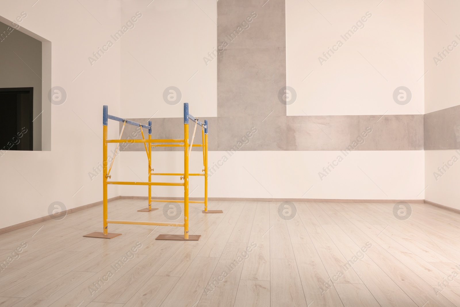 Photo of Professional construction scaffold in empty renovated room