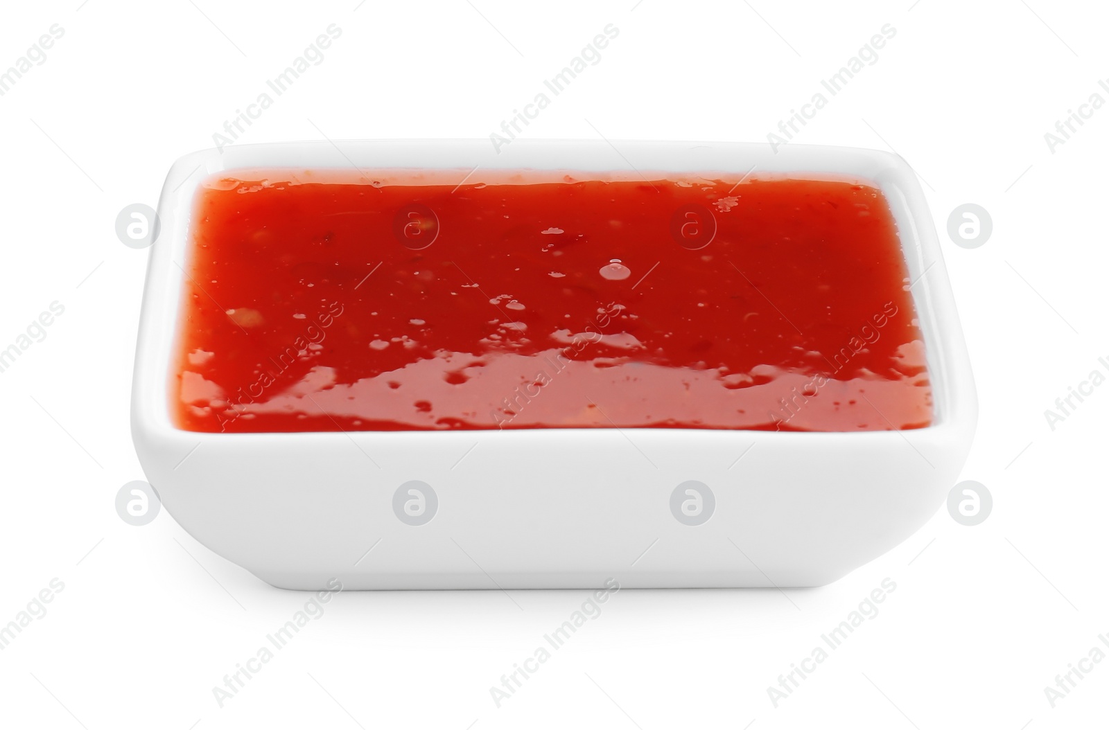 Photo of Spicy chili sauce in bowl isolated on white