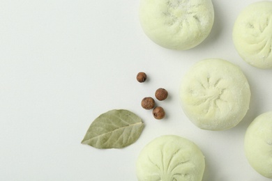 Photo of Composition with raw dumplings, bay leaf and pepper on white background, top view