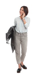 Woman holding garment cover with clothes while talking on phone, isolated on white. Dry-cleaning service