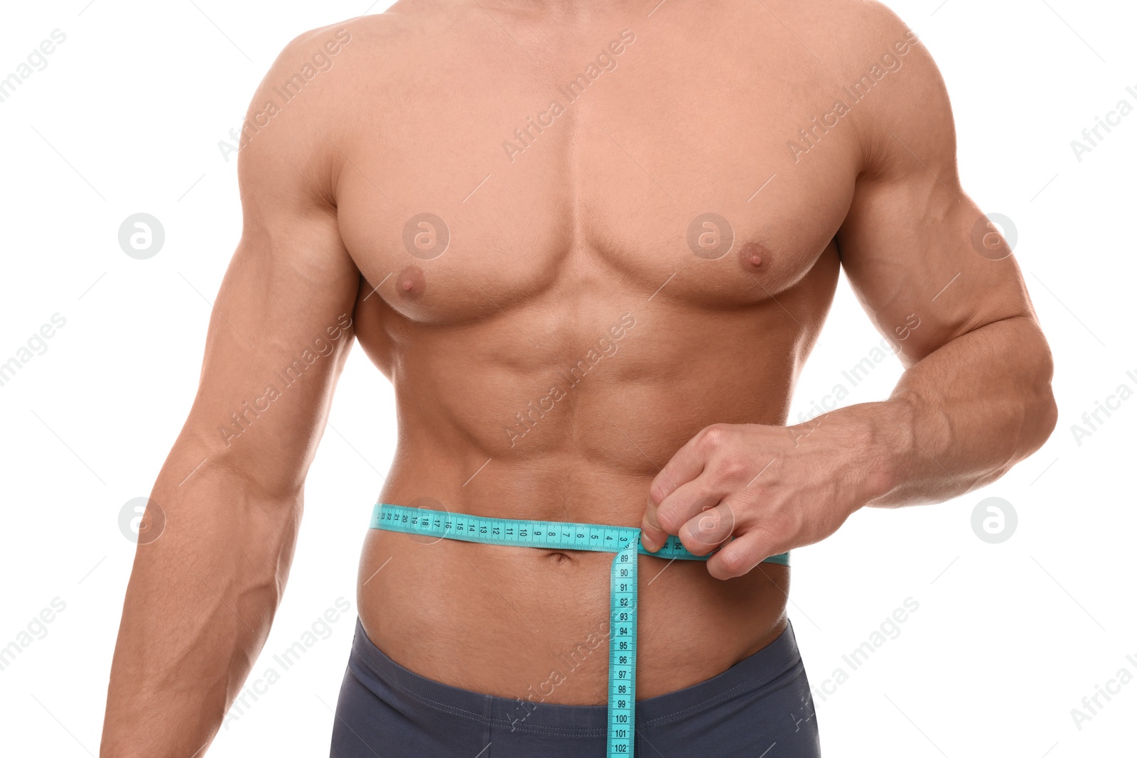 Photo of Athletic man measuring waist with tape on white background, closeup. Weight loss concept