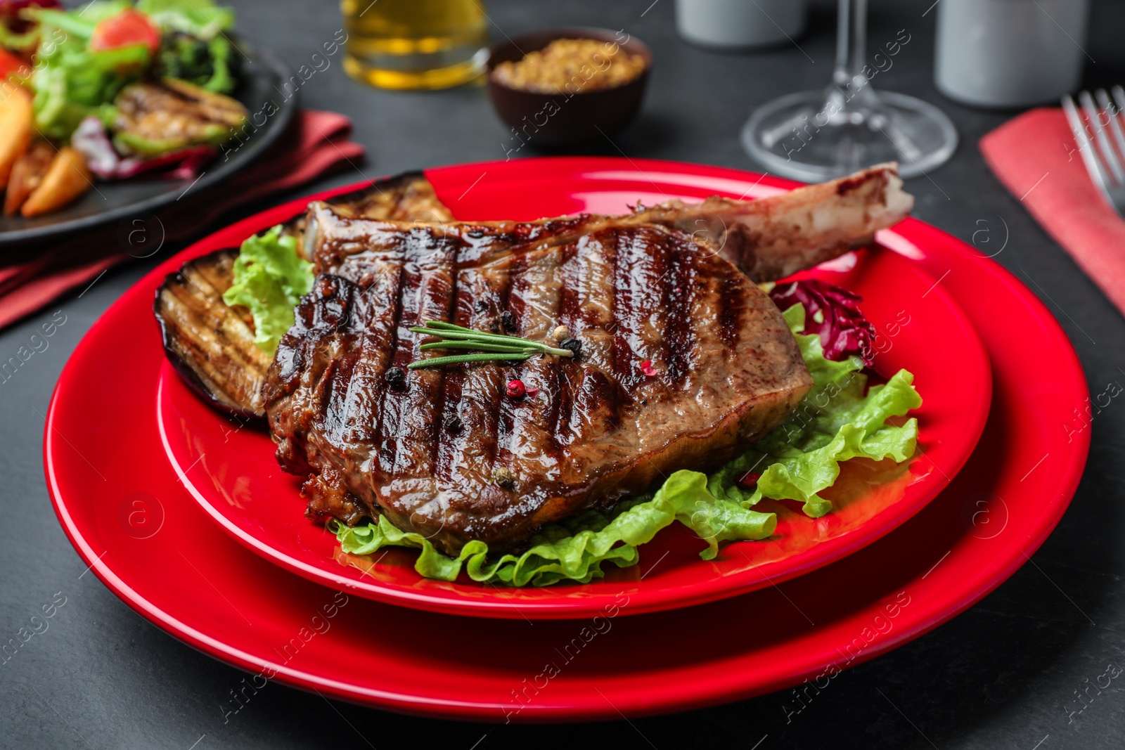 Photo of Delicious beef steak served on grey table, closeup