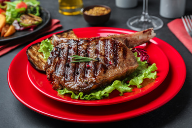 Photo of Delicious beef steak served on grey table, closeup