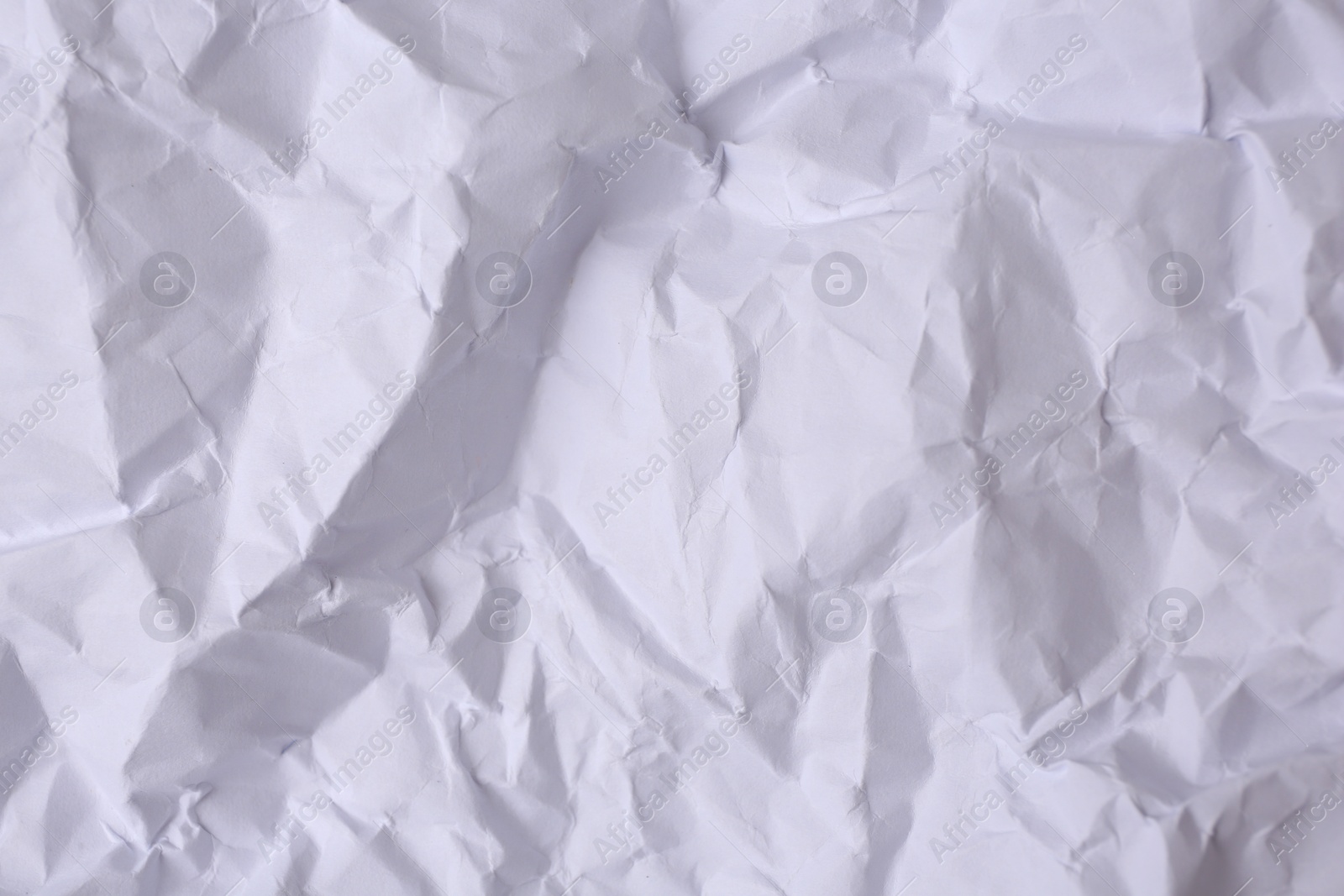 Photo of Sheet of crumpled paper white as background, top view