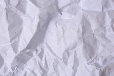 Sheet of crumpled paper white as background, top view