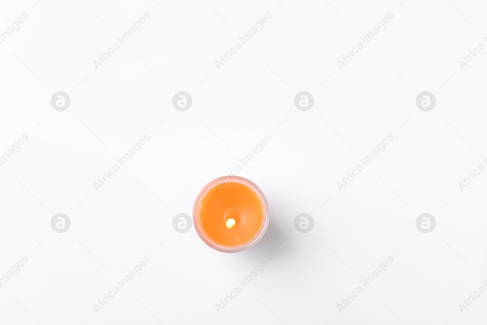 Photo of Orange candle isolated on white, top view