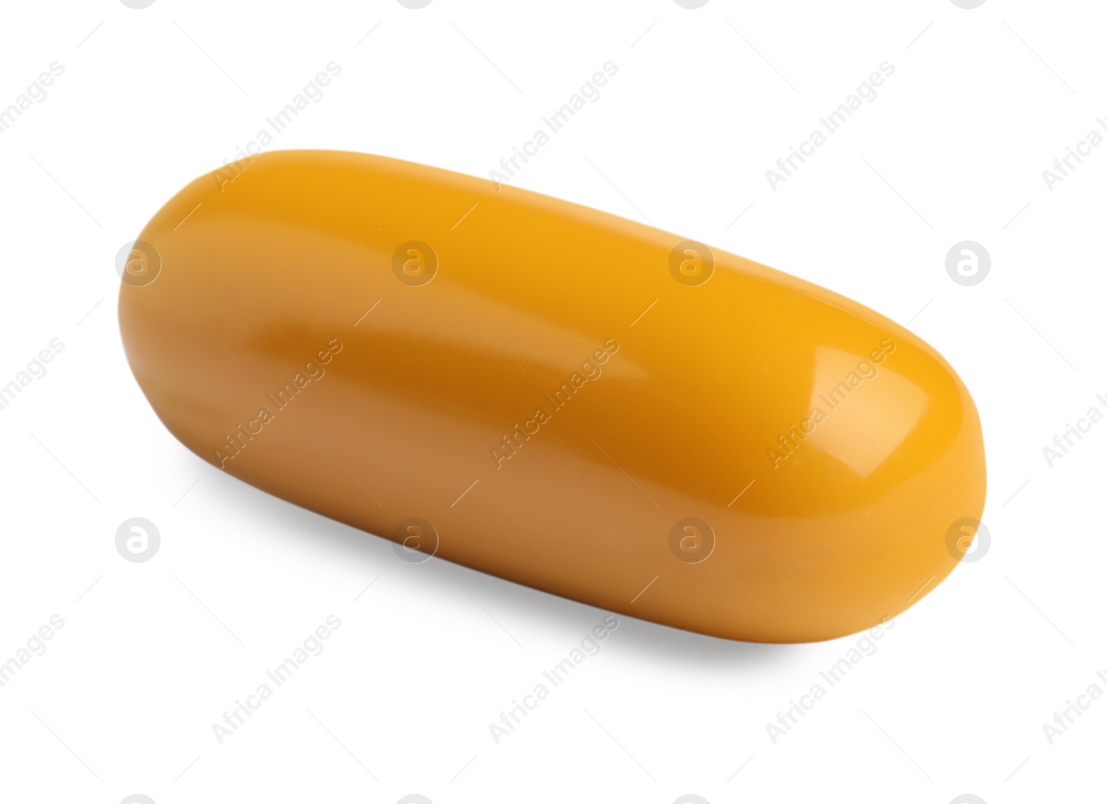 Photo of One orange pill on white background. Medicinal treatment