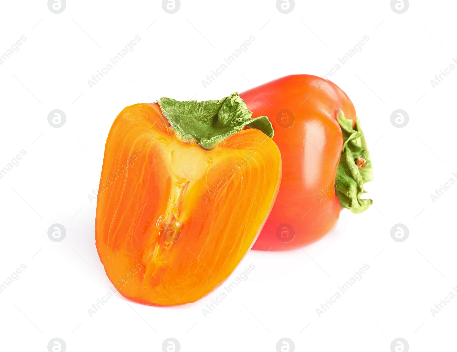 Photo of Delicious cut and whole fresh ripe persimmons isolated on white