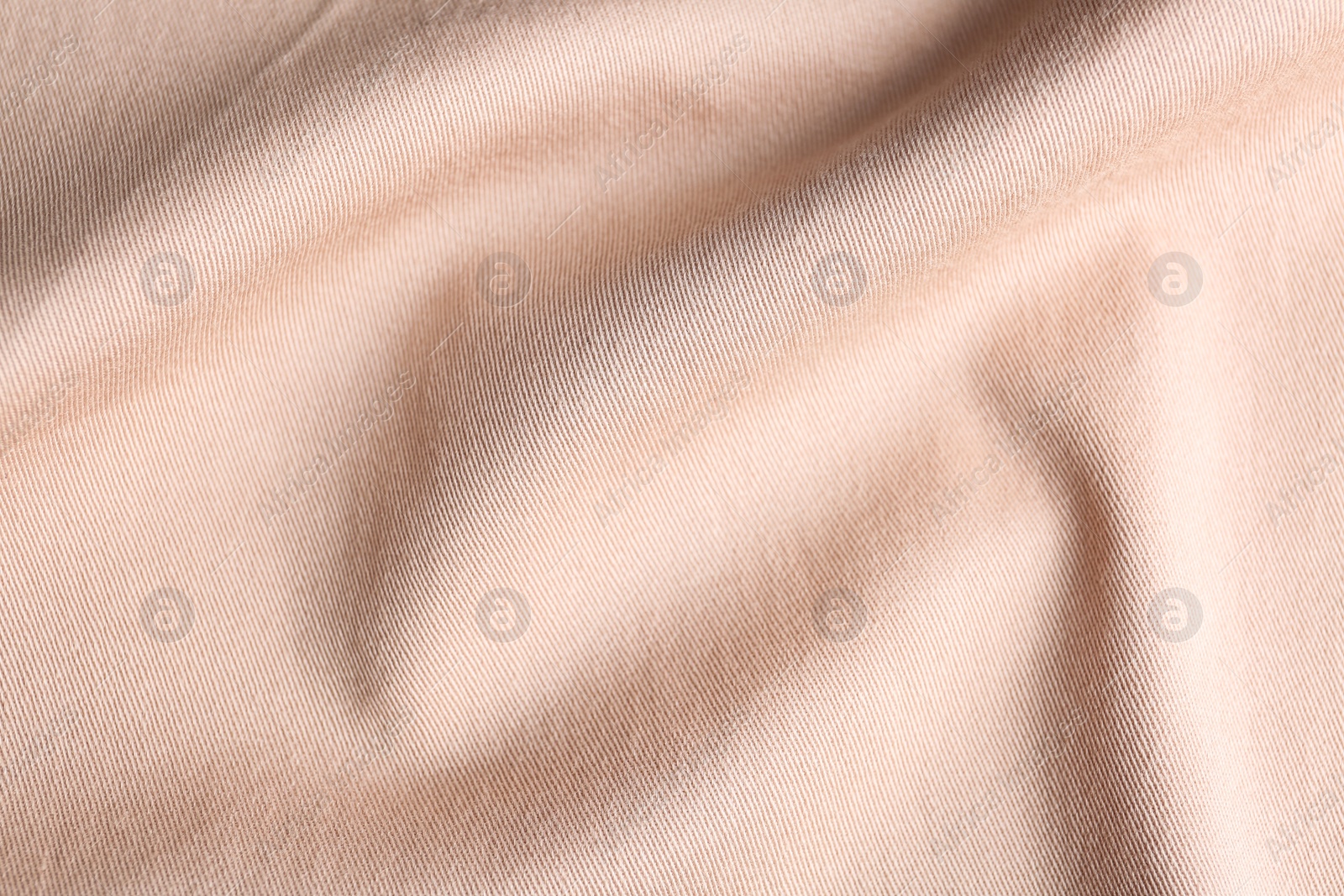 Photo of Texture of light pink fabric as background, closeup