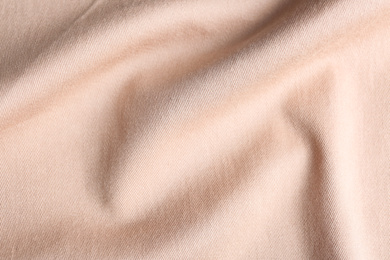 Photo of Texture of light pink fabric as background, closeup